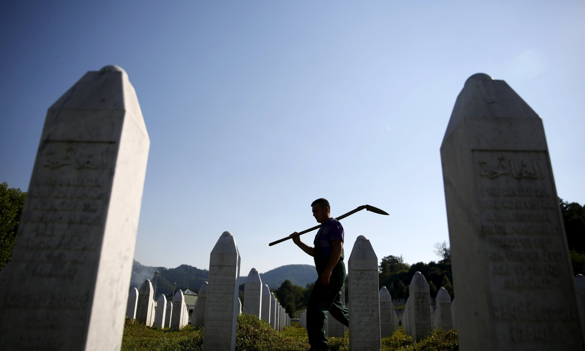 Worker tending to Srebrenica memorial graveyard  Photo: Dado Ruvic/Reuters