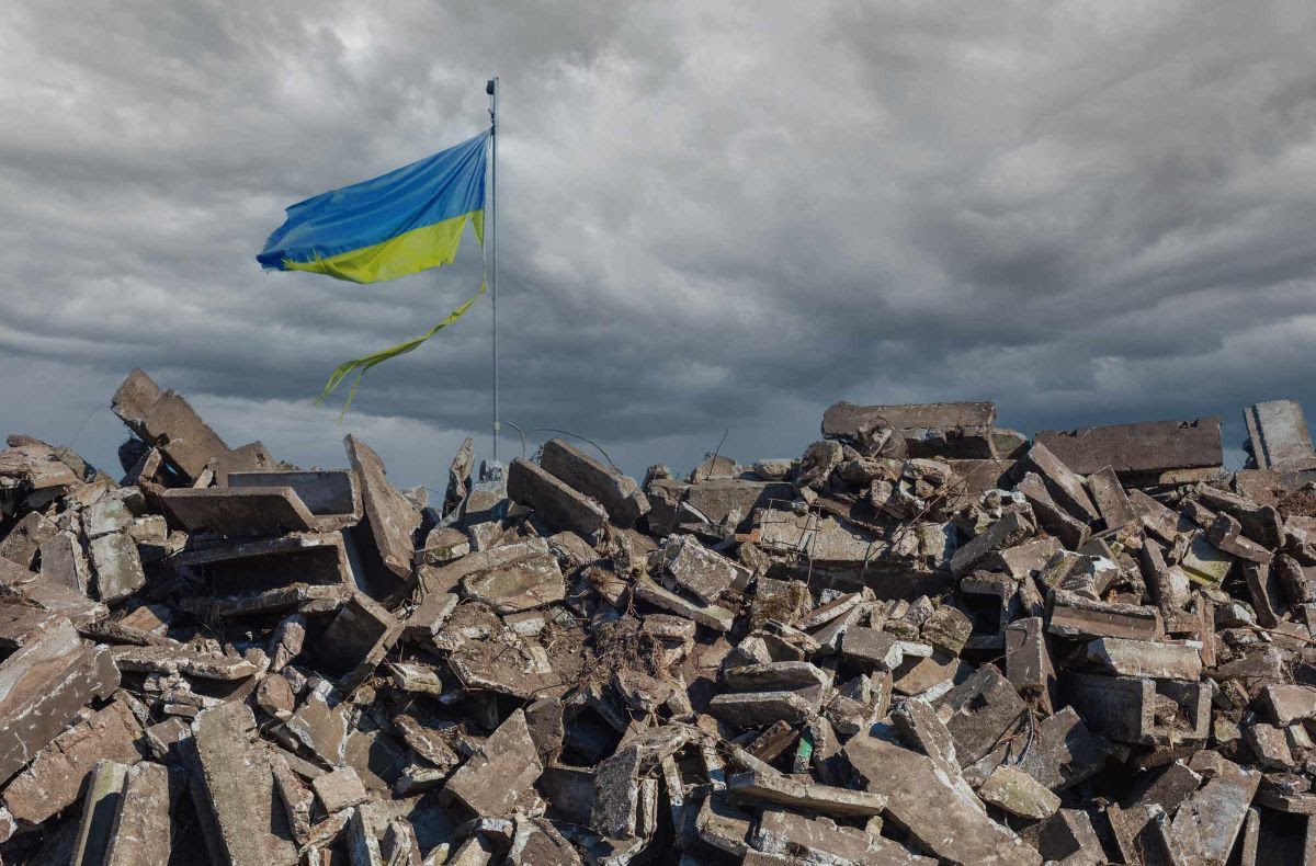 Photo of a huge pile of useless rubble with a Ukraine flag flying.