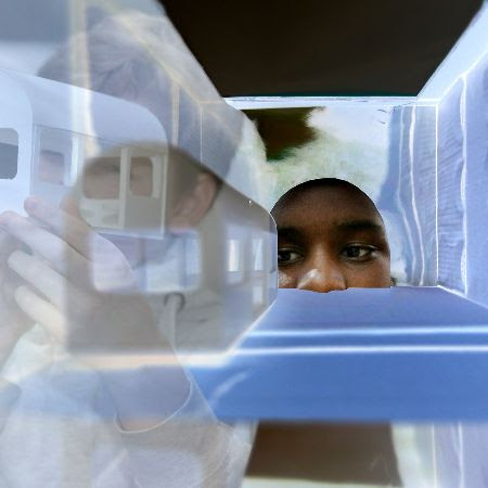 A young person looking through the new installation for My Model City