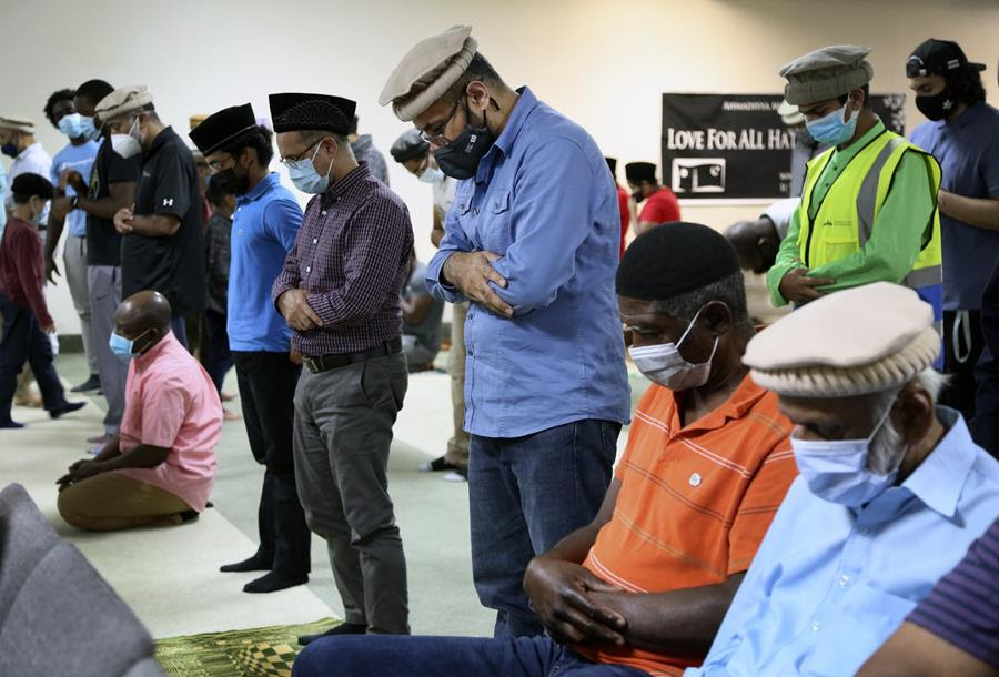 Muslim men pray together.