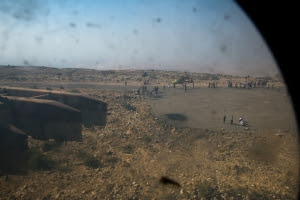 Refugees gather around a landing area awaiting an Iraqi Army helicopter carrying food and water. (ADAM MIRANI)