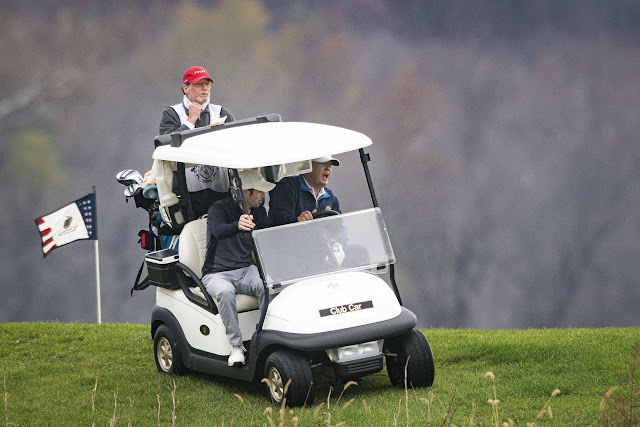 President Trump drives a golf cart on Sunday at his course in Sterling, Va. (Al Drago for The Washington Post)