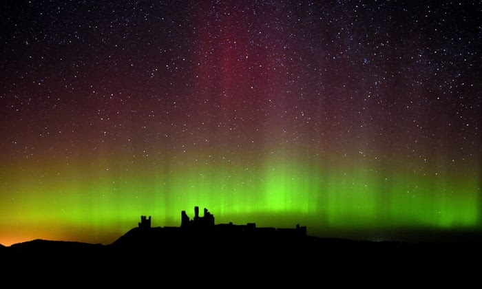 The aurora borealis over Dunstanburgh Castle in Northumberland, England. Photograph: Owen Humphreys/PA