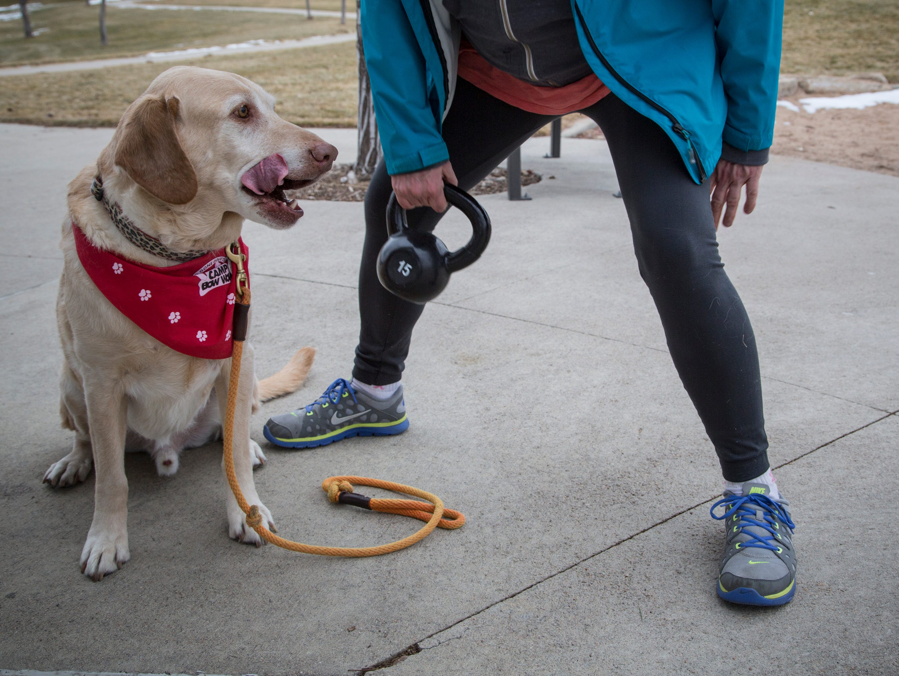 Becky Hamm works out on a circuit training regiment during one of Isabel Chamberlin's Paws4Fitness bootcamp classes in Aurora, Colo.