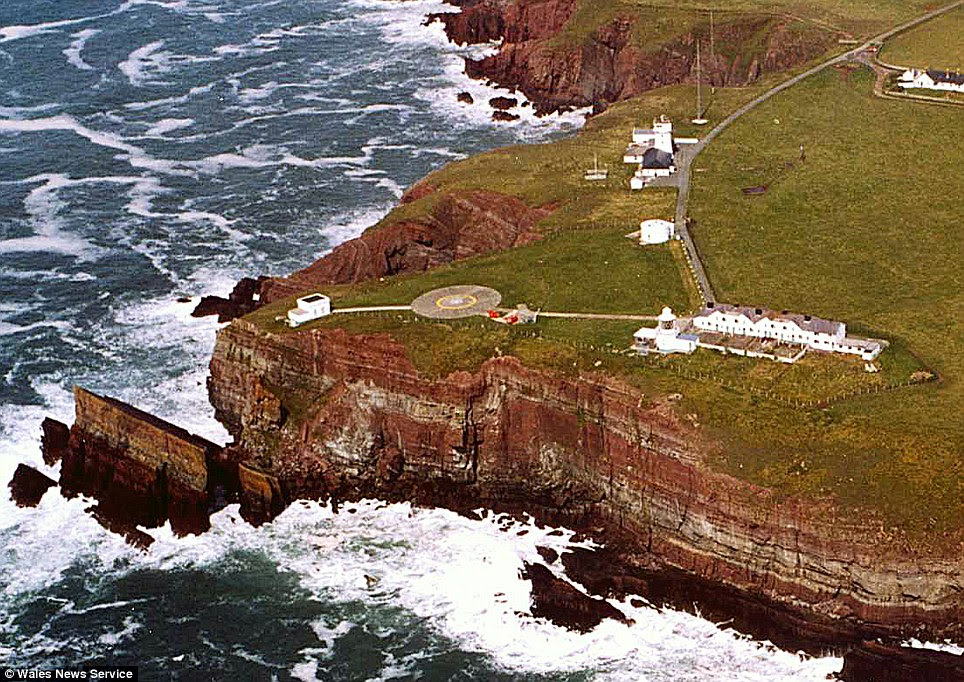 Clifftop: The five properties can be seen, right, next to a helicopter launch pad and a lighthouse which is now unoccupied