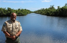 Biologist Maulik Patel stands in front of  waterway at Collier-Seminole State Park.