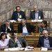 Prime Minister Alexis Tsipras, right, at a session of the Greek Parliament. Finance officials from Greece and other European nations will meet Monday on its debt.