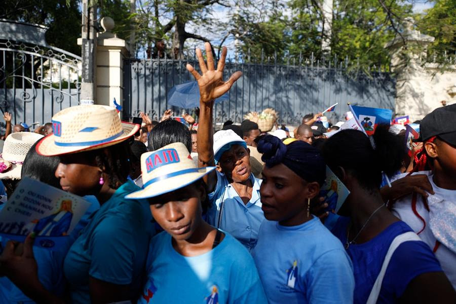 Catholic faithful participate in a procession in observance of the feast of the Immaculate Conception in Port-au-Prince, Haiti, Wednesday, Dec. 8, 2021. (AP Photo/Odelyn Joseph)