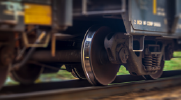 A close-up view of train wheels in motion as it speeds past on a track.  