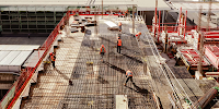 Construction workers in safety equipment viewed from above. 