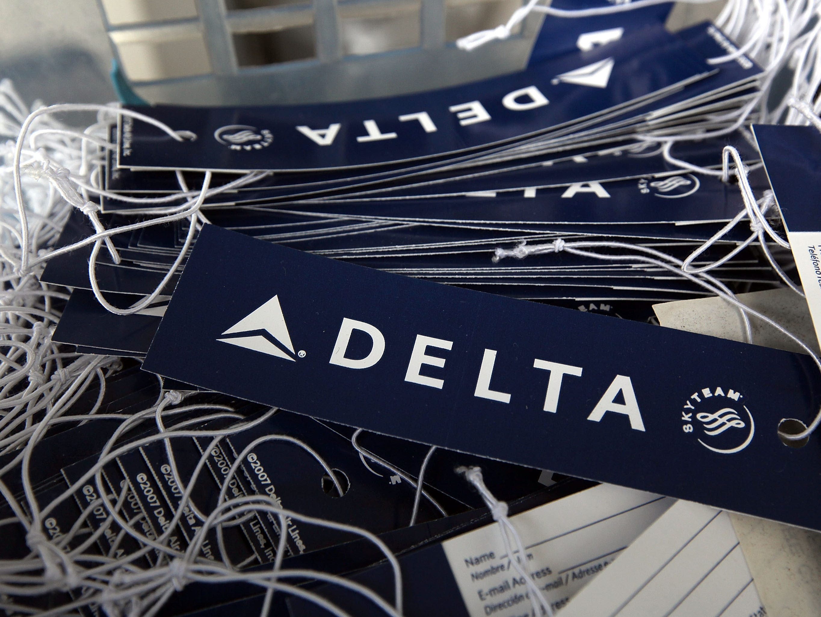 Delta luggage tags sit in a basket at a skycap kiosk at San Francisco International Airport  on Jan.  12, 2010.