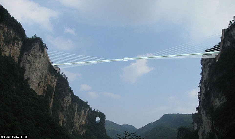 The dizzying walkway is suspended between two cliffs in the Zhangjiajie Grand Canyon area with unbeatable views of the national park