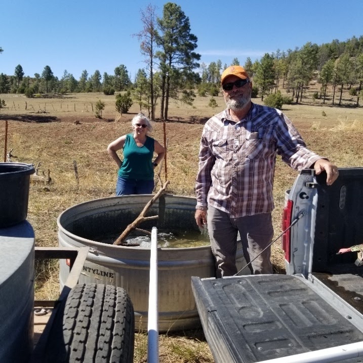 20210612 Lary and Karin filling troughs at Hall tank