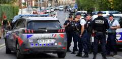 Police officers stand on a street where a house belonging to the family of Iman Hassan Iquioussen is located, in Lourches, northern France, on August 30, 2022. The Conseil d’Etat (French Council of State) gave its green light on August 30, 2022 to the expulsion of the Iman Hassan Iquioussen decided by French Interior Minister Gerald Darmanin.