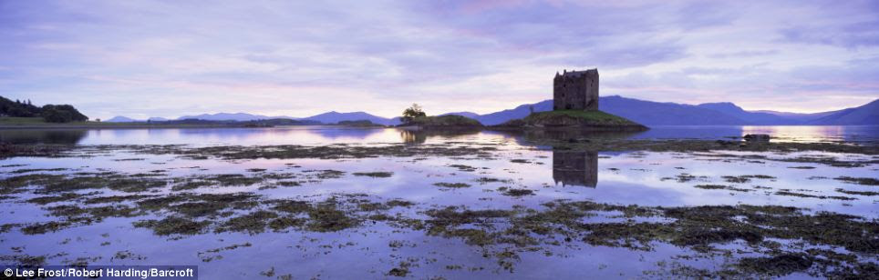 Pure beauty: A lone building throws atmospheric shadows over a breathtaking vista at the wild Loch Leven