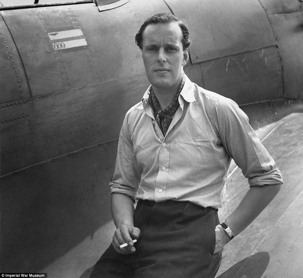 War heroes: Squadron Leader M L Robinson of No 609 Squadron RAF sits on the wing of his Hawker Hurricane at RAF Biggin Hill in 1941 for a relaxed portrait picture