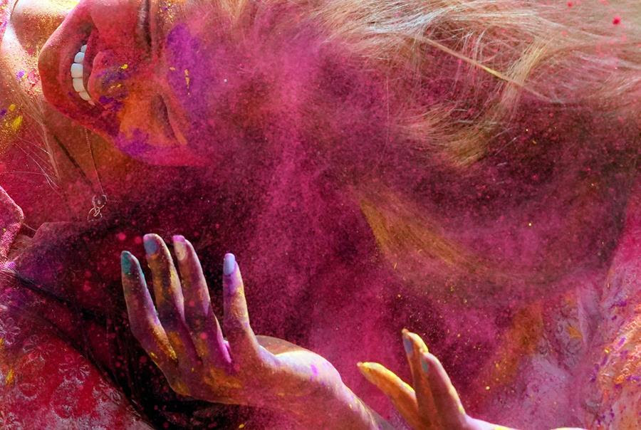 Revellers celebrate Holi, the Hindu festival of colors. The air is thick with vibrant pigments of different colors.