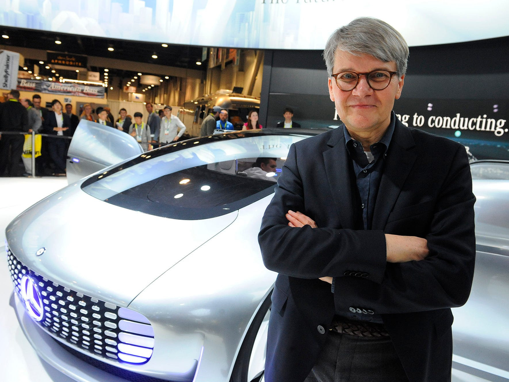 Herbert Kohler with Mercedes-Benz poses with the F015 Luxury in Motion vehicle.