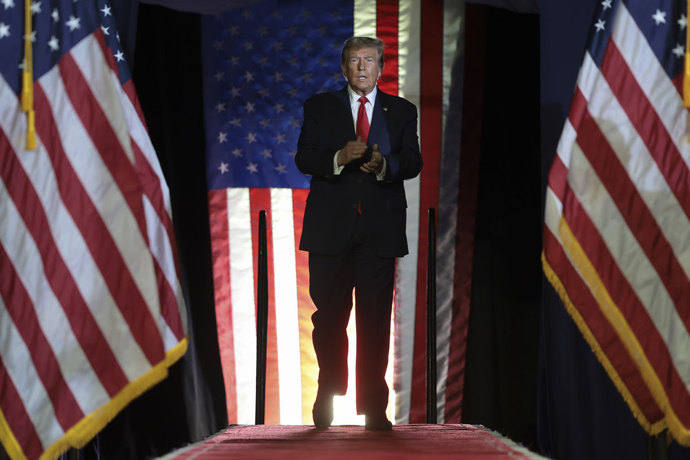 Former President Donald Trump arrives on stage during an event.