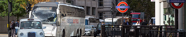 London traffic next to Tube station entrance