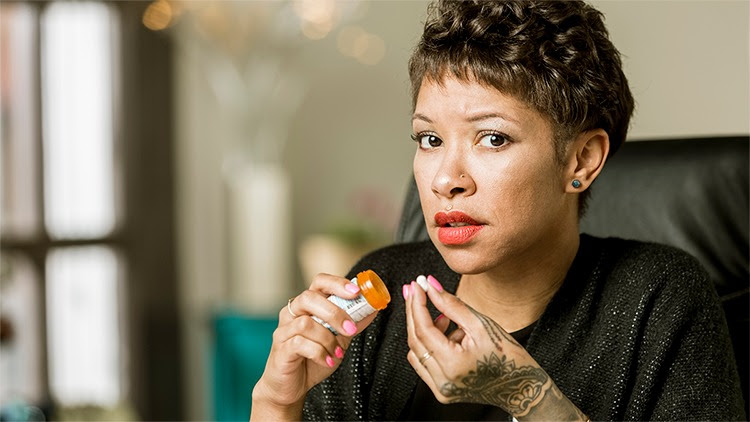 This figure shows a woman holding a pill bottle.