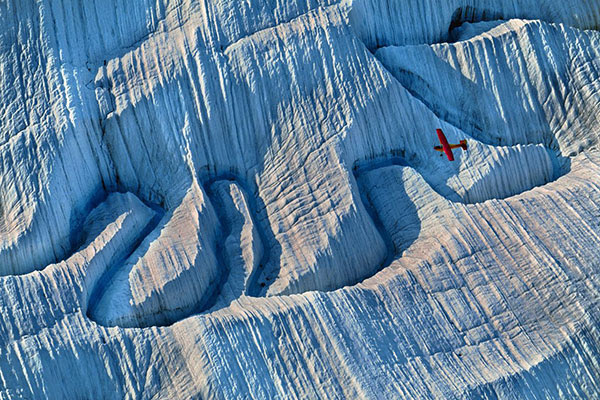 Aerial view of an aeroplane flying over a glacier in Alaska.