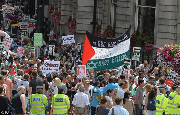 Thousands of protesters march through Whitehall in central London, to call for an end to Israeli military action in Gaza