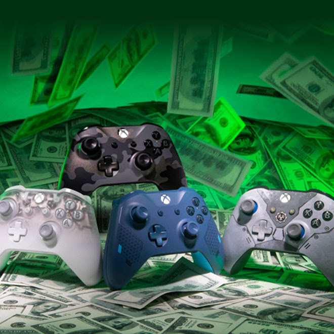 A collection of Limited Edition and Special Edition Xbox One controllers stand among a raining pile of US hundred-dollar bills.