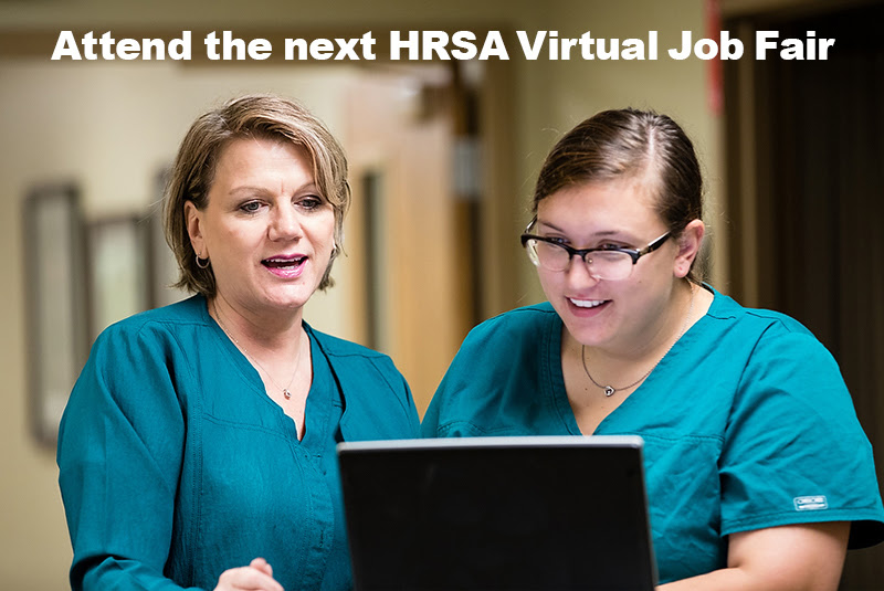 Two nurses talking and looking at computer