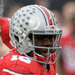 Ohio State quarterback J. T. Barrett, right, eluding Michigan defenders in the second quarter, injured his leg in the fourth quarter.