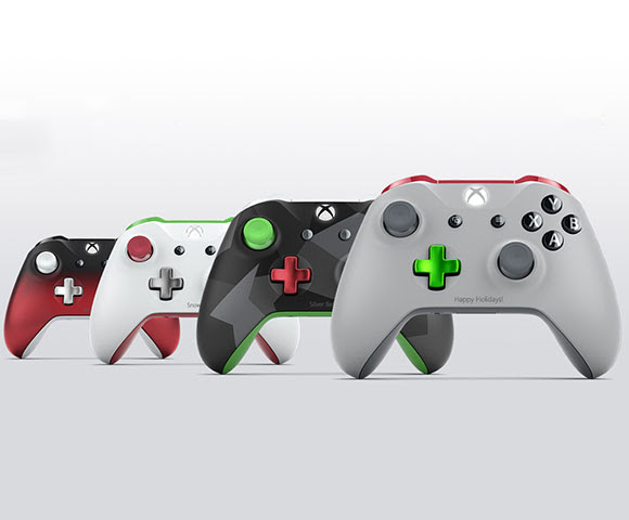 Four differently designed Xbox controllers sit aligned in a row.