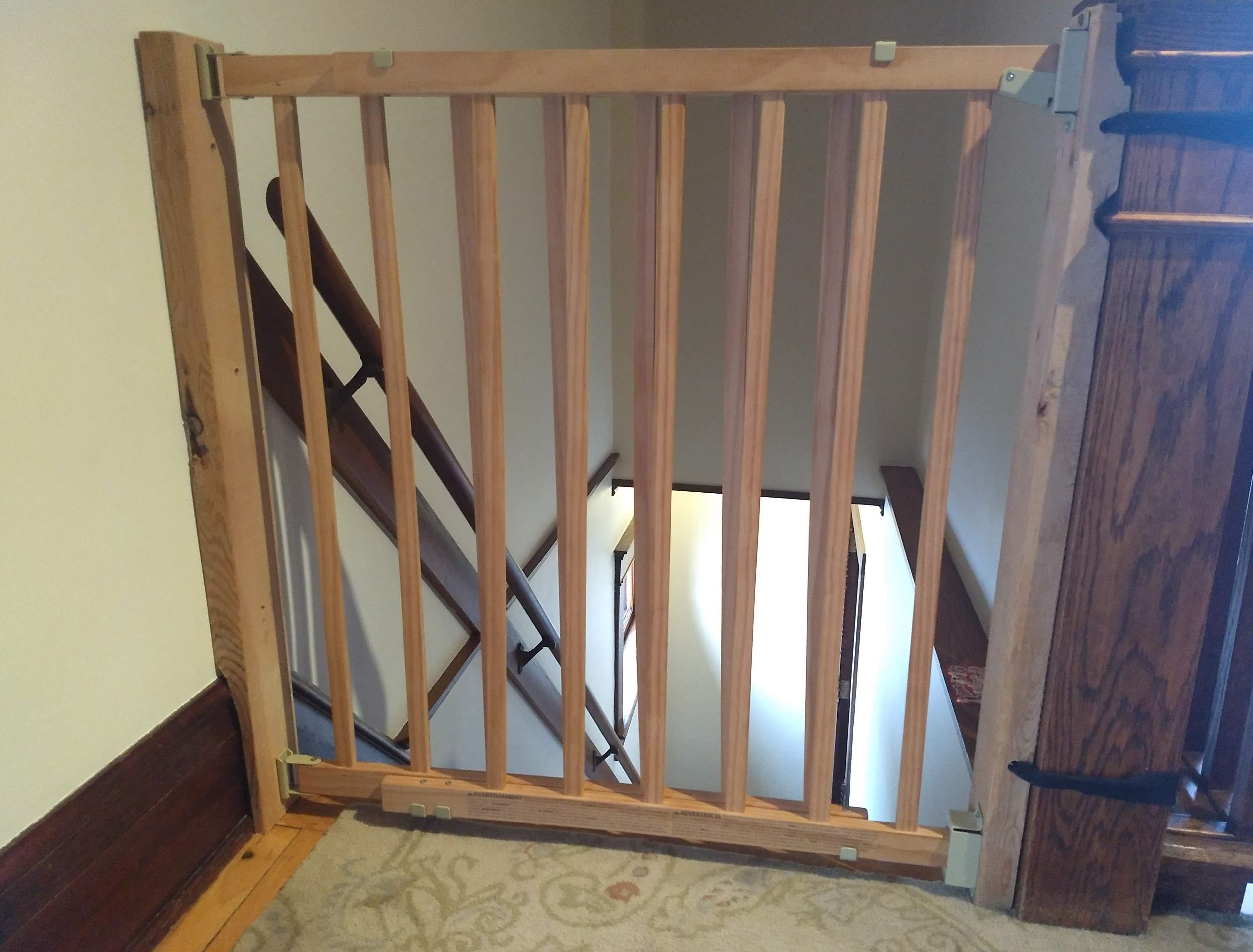 This gate is made for the bottom of a staircase with a wall side and a banister side. Installing A Top Of Stairs Baby Gate Without Drilling Into Wood Trim Or Banister Post Samfirke Com