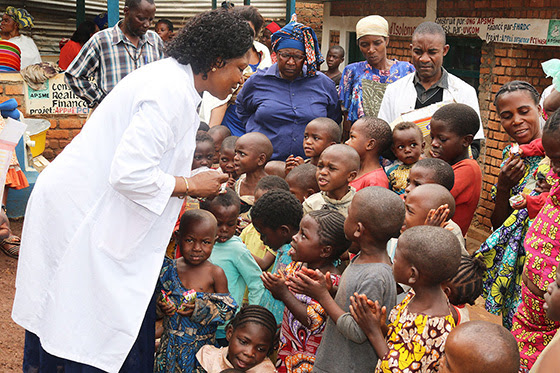 Dr. Marie Claire Manafundu, who coordinates the church’s Maternal and Child Health Program in eastern Congo, talks with children outside of United Methodist Irambo Health Center in Bukavu, Congo. The United Methodist Church in East Congo offers food support to families affected by HIV and AIDS. Photo by Philippe Kituka Lolonga, UM News.