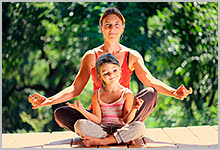 A woman and child doing yoga.