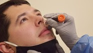 man gets swab in nose for coronavirus test