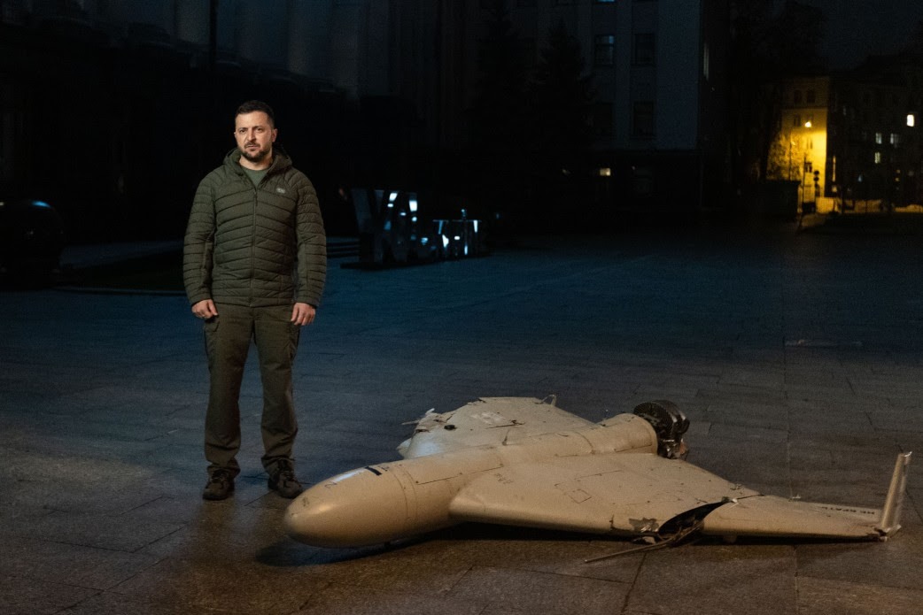 Zelensky standing next to a small drone that crashed.