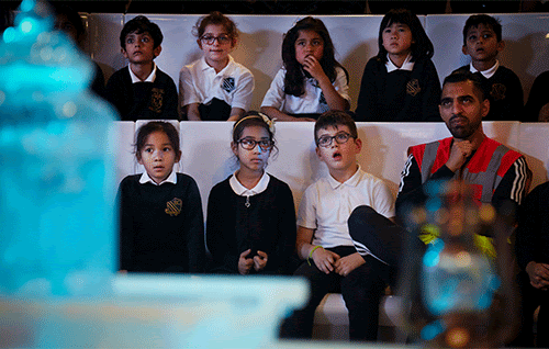 A group of children and an adult sat in the Museum's Attenborough Studio while taking part in our Ocean Life and Habitat show.