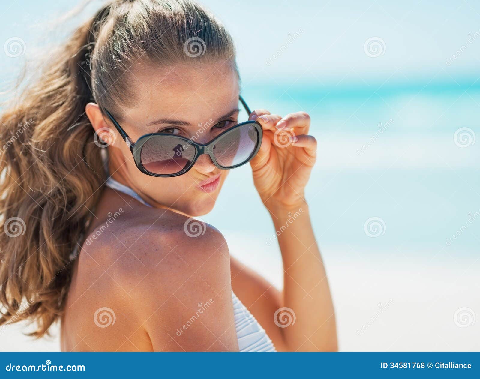Portrait Of Young Woman  In Swimsuit On Beach  Making Funny  