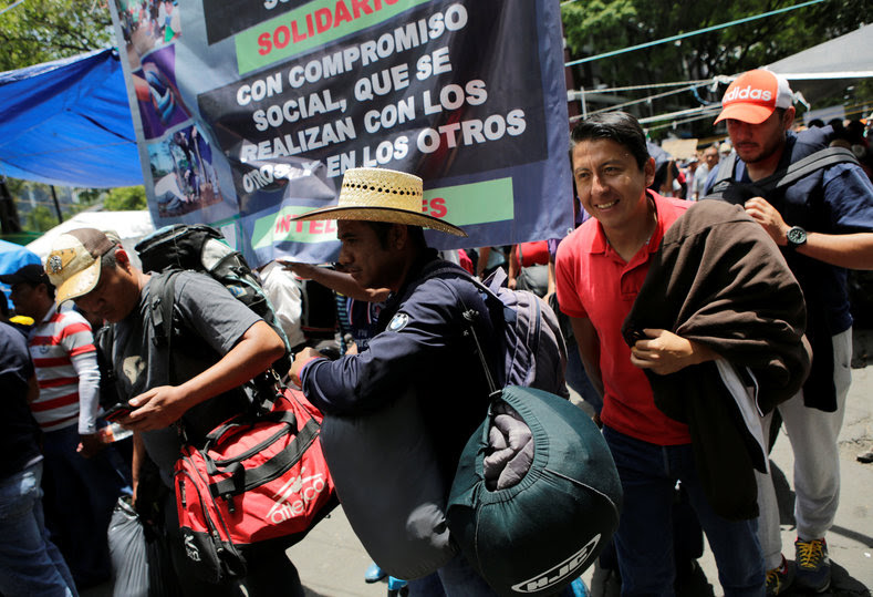 Protesters from the National Coordinator of Education Workers (CNTE) teachers’ union arrive in Mexico City to attend the march against President Enrique Peña Nieto