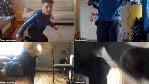 A zoom recording split four ways with one kid break dancing in each corner. 