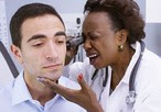 Doctor inspecting patient's ear