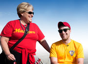 Man in a wheelchair with a woman standing to his side