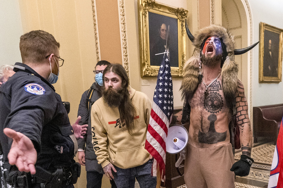 Photo inside the Capitol with the Qanon Shaman howling.