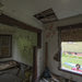 Mary Van looks into the vacant living room of the abandoned house at 569 Mount Vernon Street.