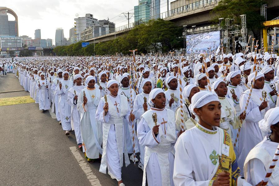 People celebrate the Ethiopian New Year. They are dressed in white.