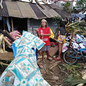 woman standing in rubble