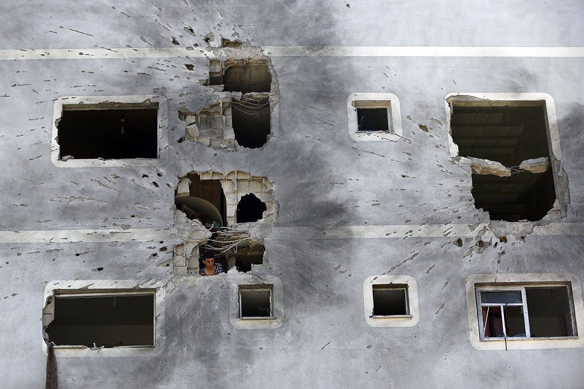 A Palestinian man inspects the damage to his home in Jabaliya in the northern Gaza Strip