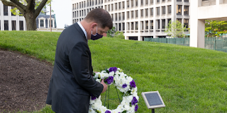 Secretary Walsh lays a wreath at a Workers Memorial plaque at Department of Labor headquarters