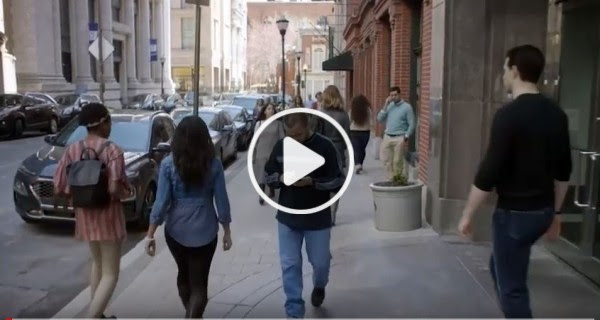 Screenshot of Suicide Lies video. Man walking in the street. 