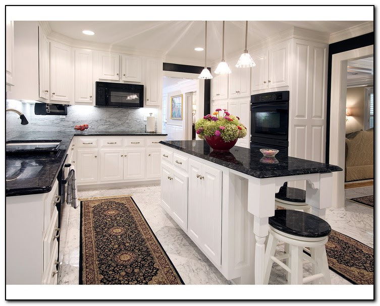 white kitchen cabinets with black countertops